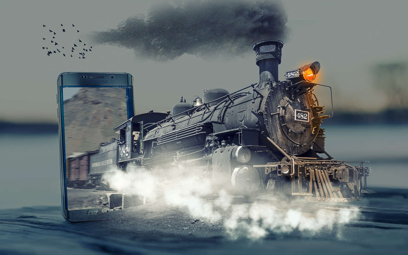 Un train à vapeur qui sort d'un écran de smartphone